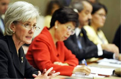 PHOTO: HHS Secretary Kathleen Sebelius speaks, seated at a table with others
