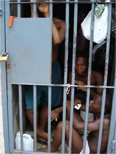 Three male prisoners in prison cell about three feet wide